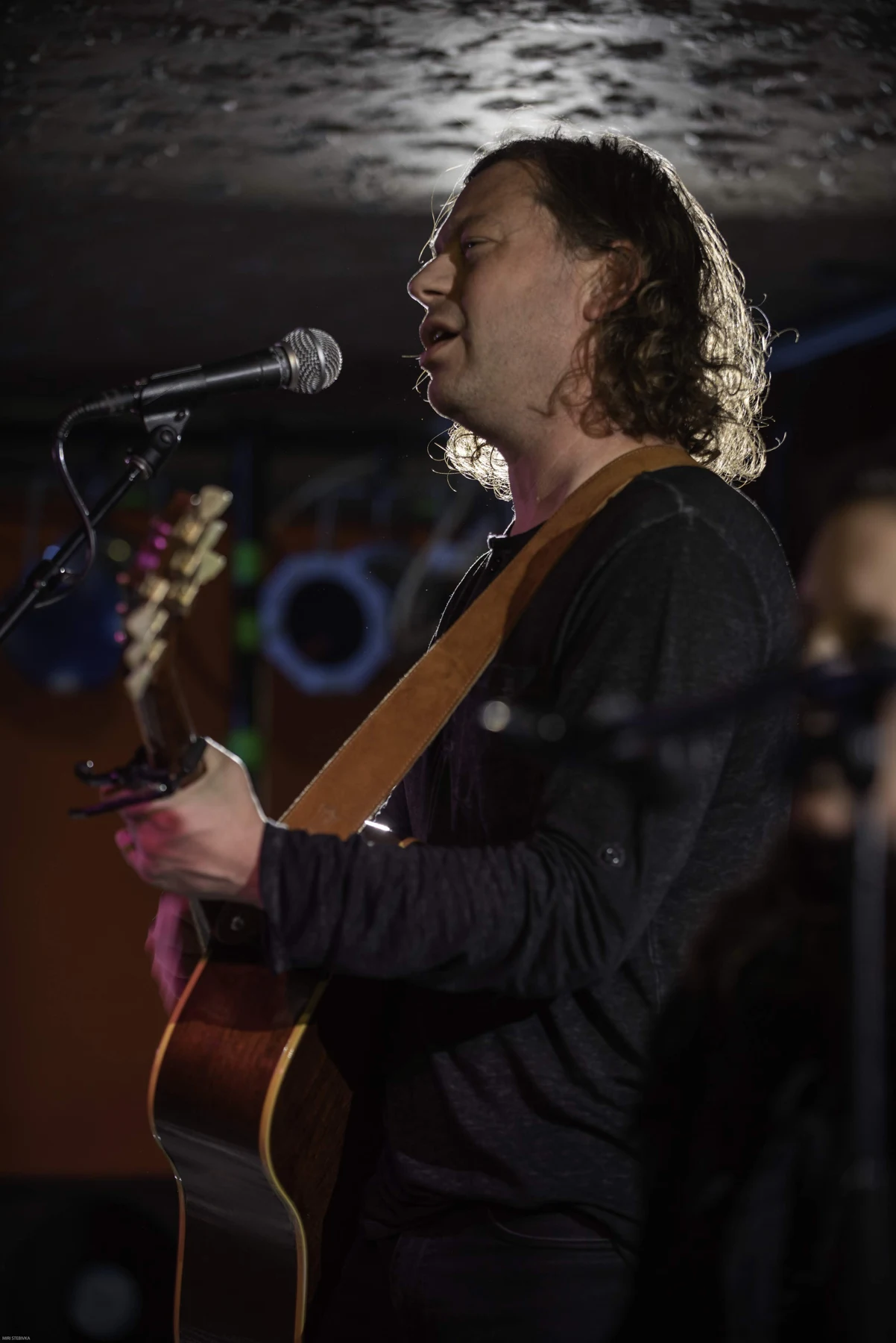 Brian performing on acoustic guitar